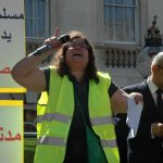 A demonstrator shouting slogans to condemn Christian persecution in Egypt