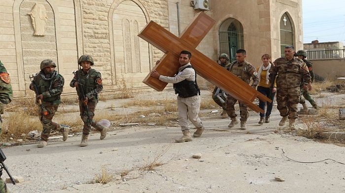 KURDISH SOLDIERS RESTORE CHURCH CROSS AND BELL DESTROYED BY TERRORISTS IN BASHIQA